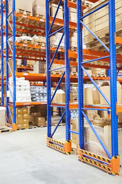 Huge distribution warehouse with high shelves and loaders